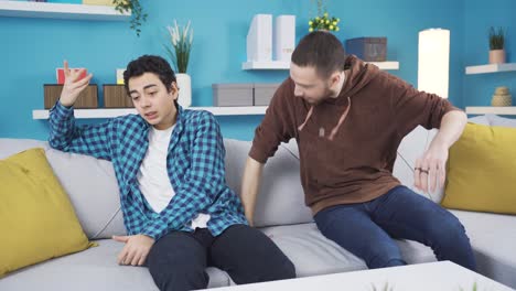 young older brother listening to his sad brother and giving him morale.