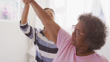 Senior-mixed-race-woman-exercising-at-home.-Social-distancing-and-self-isolation-in-quarantine