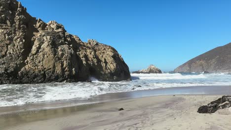 Waves,-sand-and-rock-formation-on-a-wild-beach