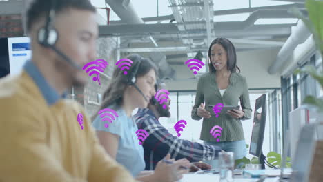 animation of wifi icons and data processing over diverse business people in office