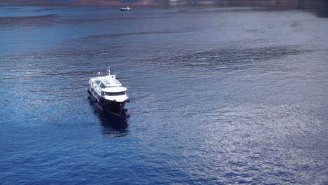 Tender-boat-ferry-front-view-on-blue-sea-with-caption-space