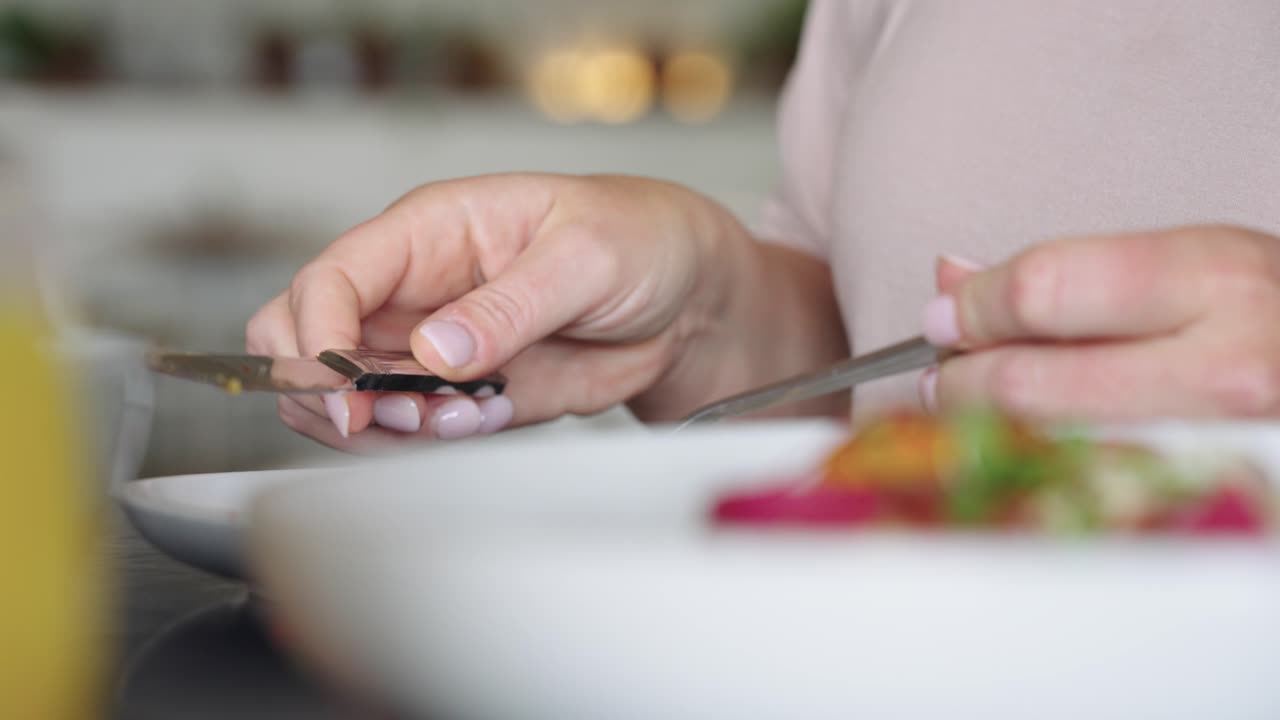 4K footage of a woman adding food to her plate at an elegant brunch table, capturing social dining, plated dishes, and upscale restaurant brunch atmosphere