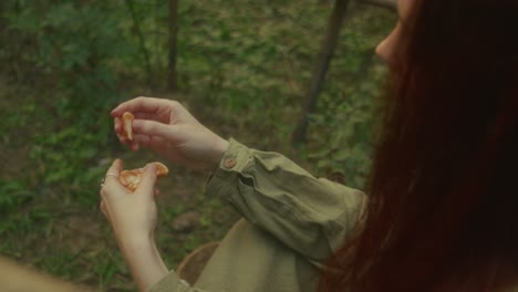 woman eating an orange in a garden