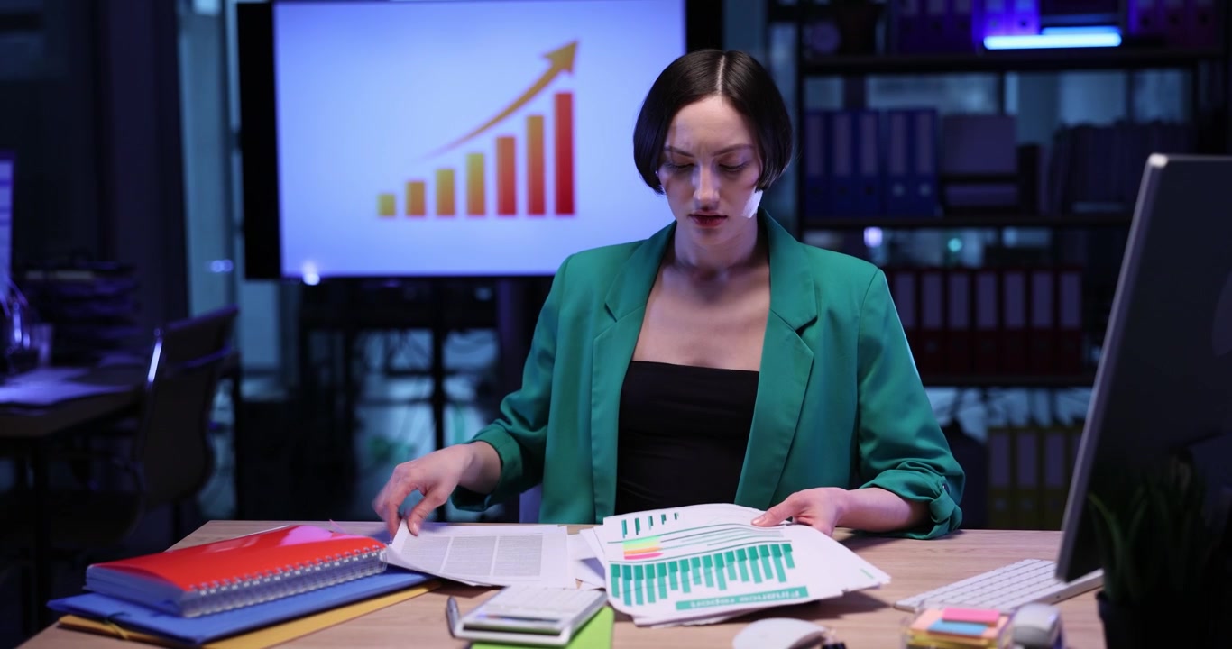 Stressed woman employee checks and throws away papers in office
