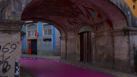 The-Famous-Pink-Street-With-Arched-Alley-In-Lisbon,-Portugal