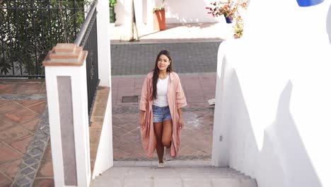 woman walking up stairs in a charming european town