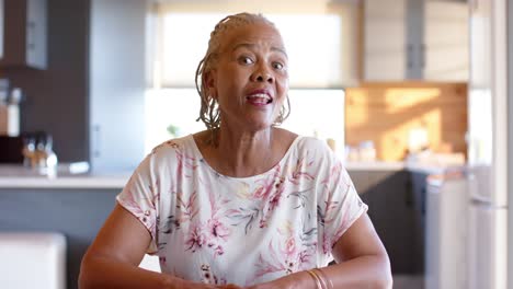 happy senior african american woman making video call at home, slow motion