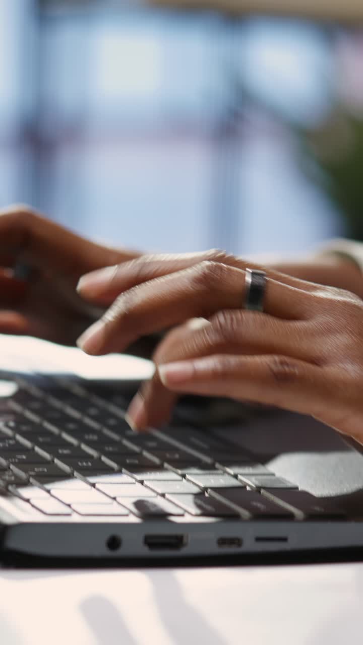 Vertical video Freelancer in home office typing on laptop keyboard, close up