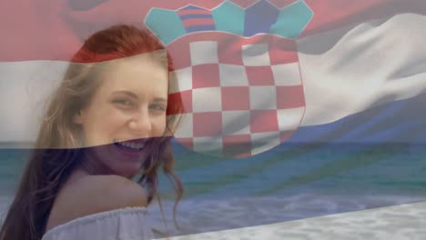 animation of flag of croatia over caucasian woman at beach