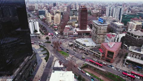 Bird's-eye-view-establishing-the-Tobalaba-sector-with-the-MUT-Tobalaba-Urban-Market,-high-vehicular-traffic-with-high-contrast-of-infrastructure