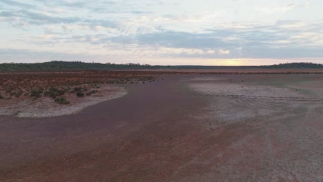 Drone-clip-over-remote-salt-lake-in-Western-Australia,-showing-trail-of-footprints