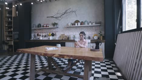 woman using phone in a modern cozy kitchen