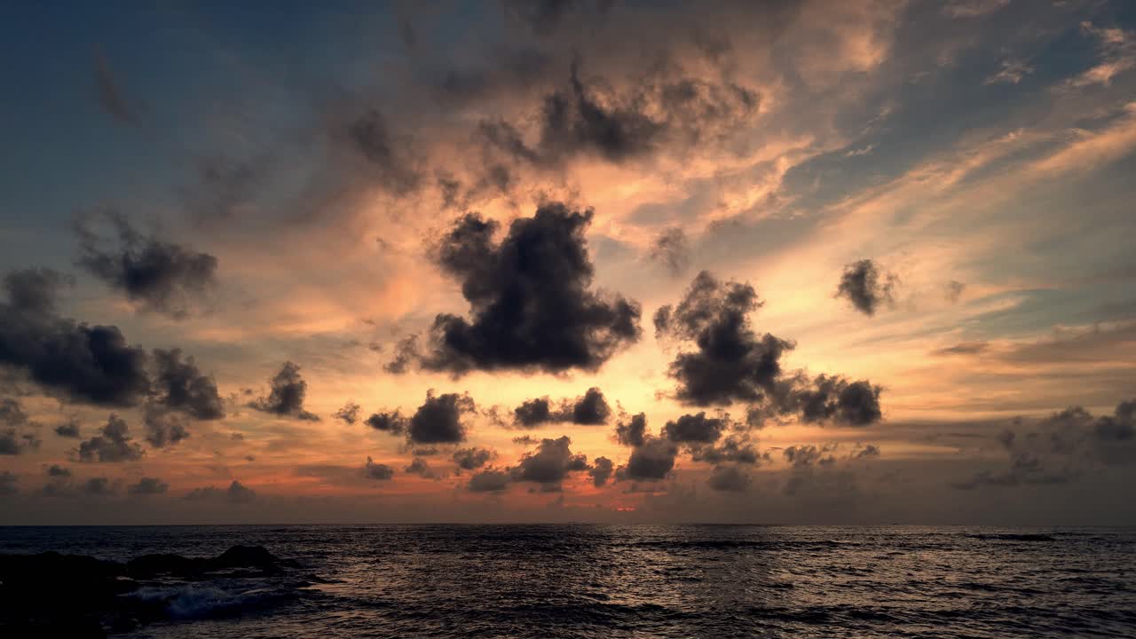 Scenic Sunset Over the Sea with Clouds and a Lighthouse
