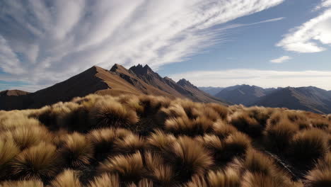 Vast Mountain Landscape with Golden Grass and Dramatic Sky