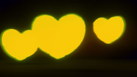 yellow energy heart shapes on a dark background
