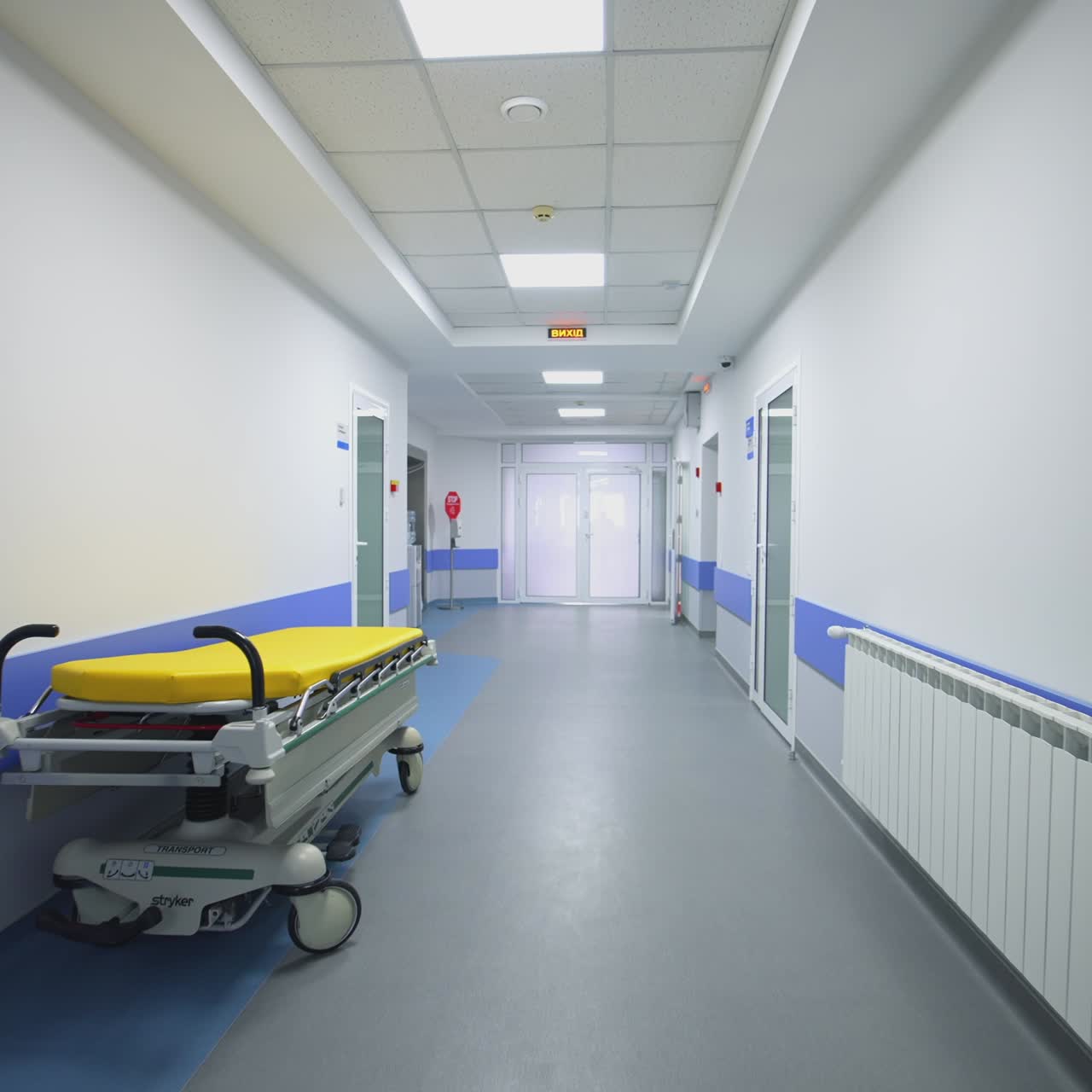Long empty corridor of hospital. Long hallway with medical gurney in the hospital