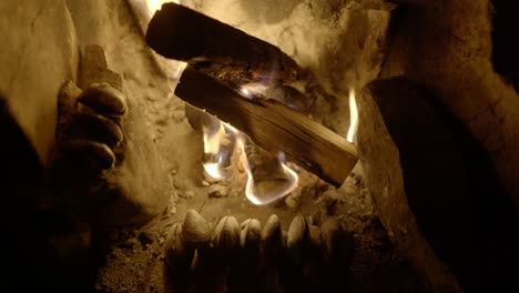 wild foraged mussels slowly cook in front of a slow burning log fire in an old fireplace