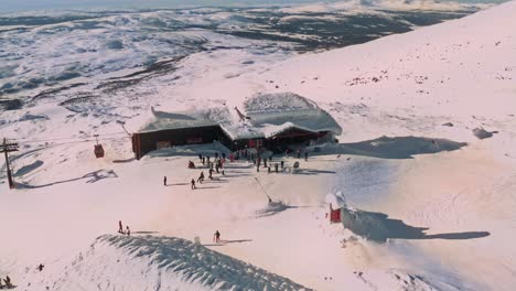 an alpint lift house covered with snow