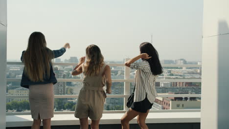 three friends enjoying rooftop views