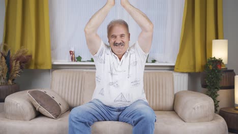 old man giving greeting and applause to camera.