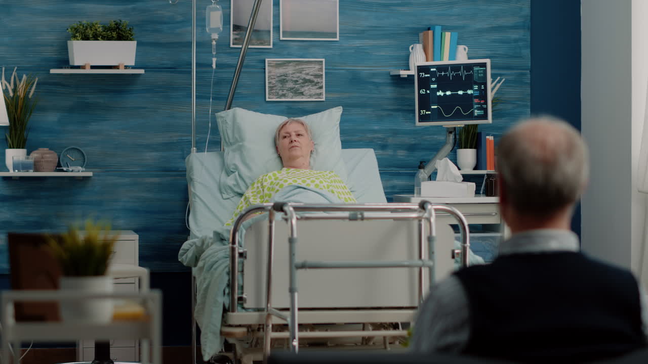 Medical team doing consultation with sick patient in bed