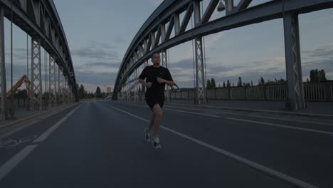 an athlete goes running, jogging on a bridge on the main in frankfurt