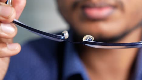 broken eyeglasses in hands