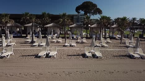 Low-angle-shot-of-sandy-beach-beds-for-travelers-to-relax