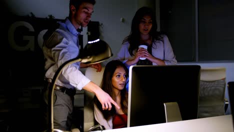 Executives-discussing-over-computer-at-desk