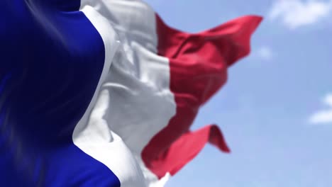 detail of the national flag of france waving in the wind on a clear day