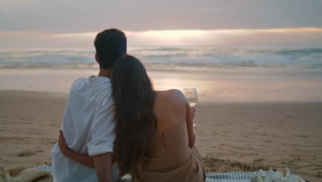 affectionate newlyweds embracing sunset. couple enjoy marine landscapes vertical