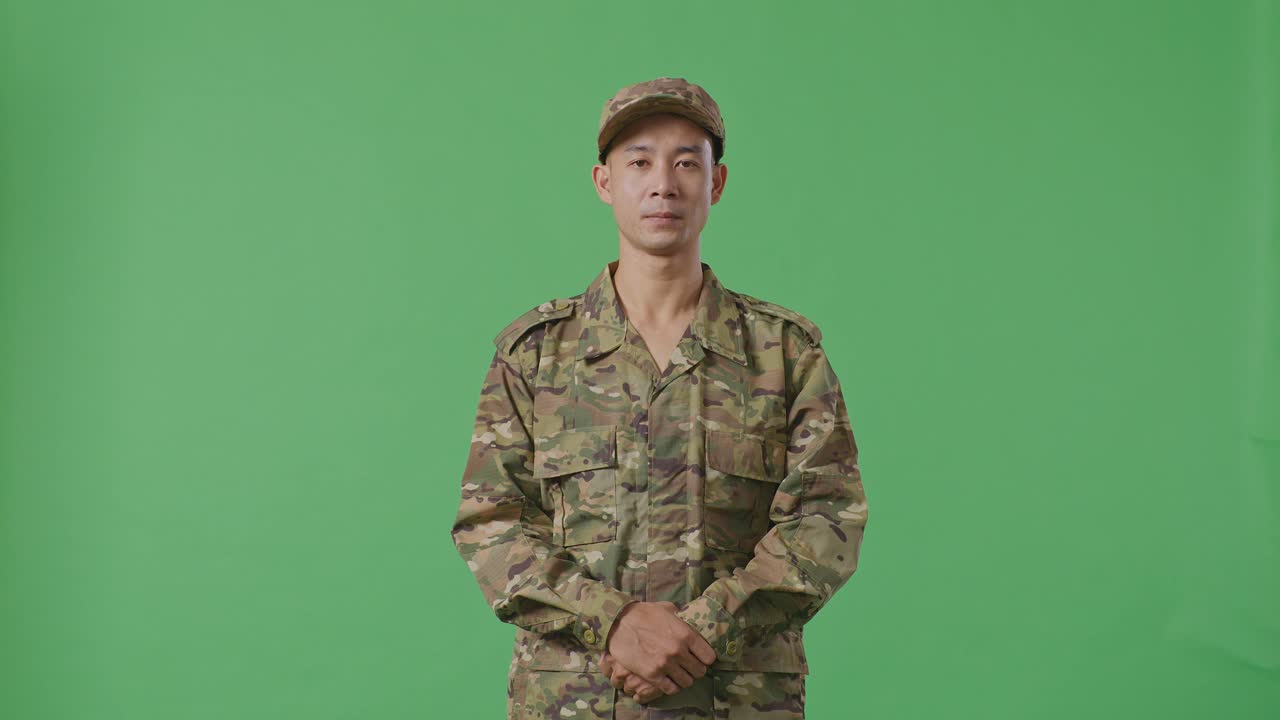 Asian Man Soldier Standing And Looking To Camera In The Green Screen Background Studio