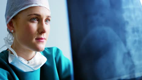 female doctor examining x-ray