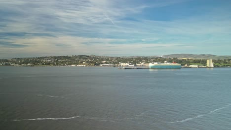 a panning aerial view capturing the benicia-martinez, featuring calm waters, rustic docks, and a picturesque coastal atmosphere