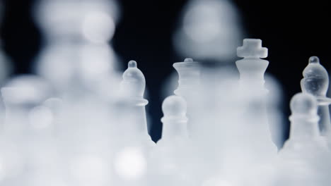 looking at the two sides on a chessboard, pieces made of glass, slowly rotating