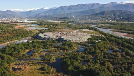 Aerial-view-–-tremendous-landfill-impacts-the-nature-in-Black-sea-water-area,-Batumi-suburb,-Chorokh-river,-Georgia