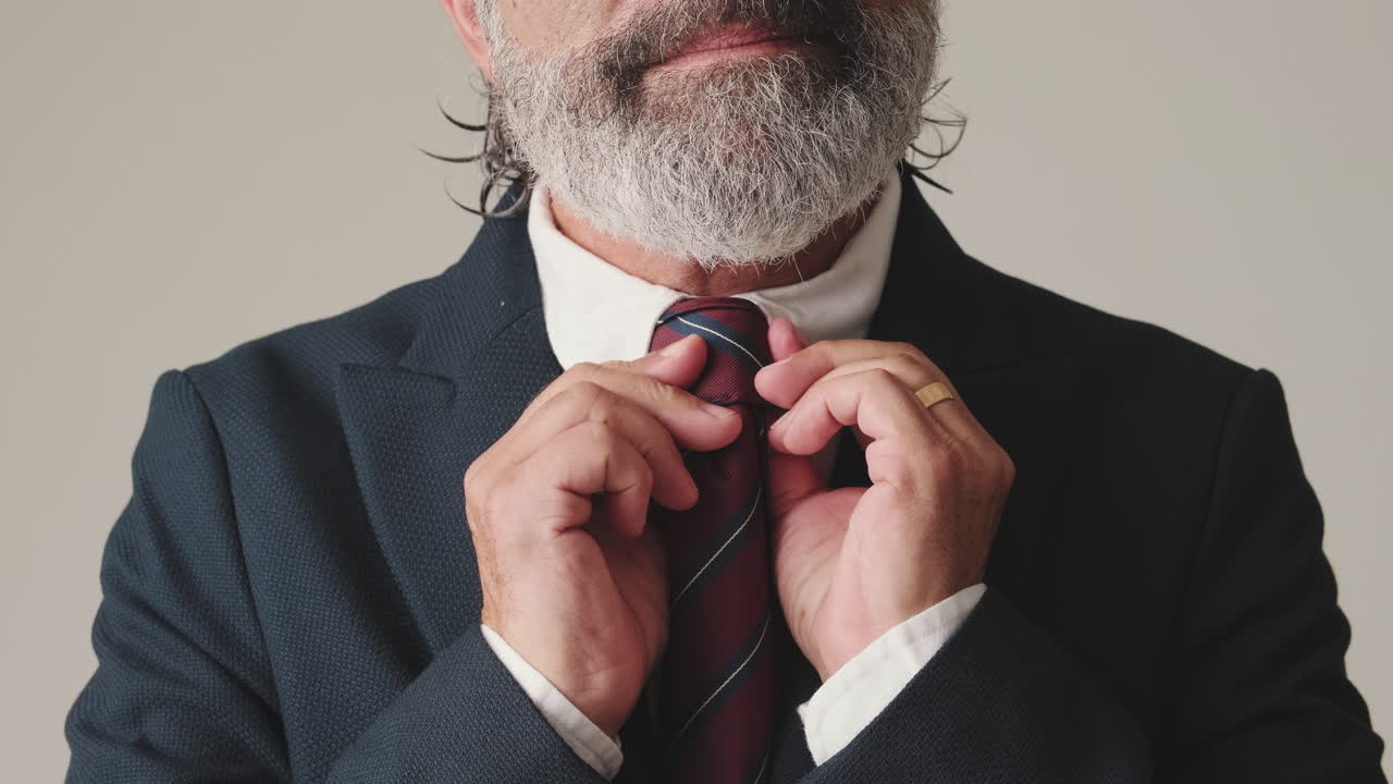 Close-Up of a Businessman Adjusting His Tie