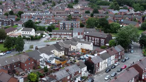 aerial view above british neighbourhood small town residential suburban property gardens and town streets left dolly