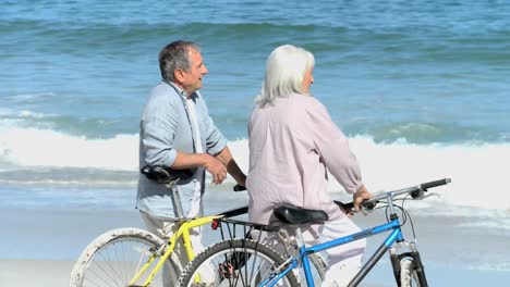 elderly man talking with his wife after a bike ride