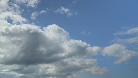 bright nimbus clouds rolling across the blue sky and boiling off in the sunlight