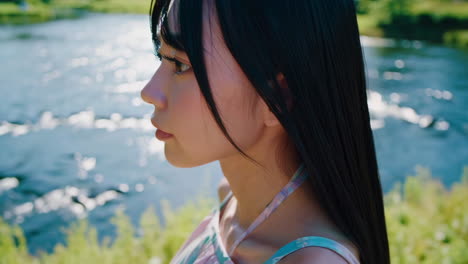 young woman by a river