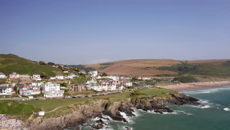 rising aerial shot of a seaside town on a perfect summer’s day