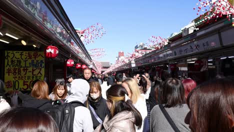 crowded outdoor market with shoppers and decorations