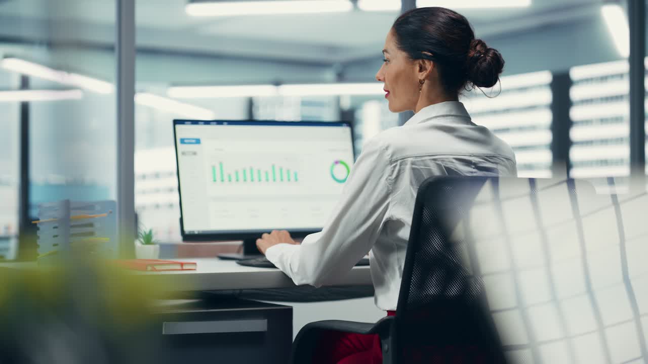 Successful Caucasian Businesswoman in Working on Computer in City Office. Female CEO Managing Stock Market Portfolio, Doing Big Data Analysis, Information, Statistics, Graphs and Chart