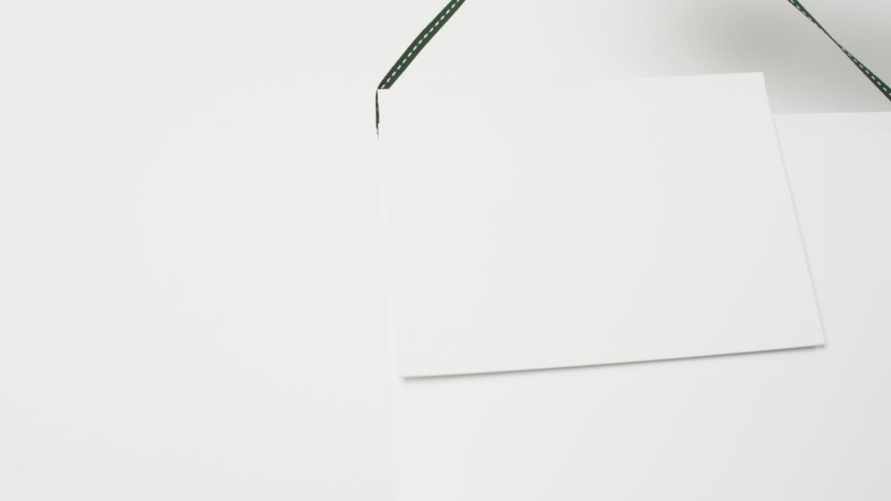 Video of books on hanger with white blank pages and copy space on white background