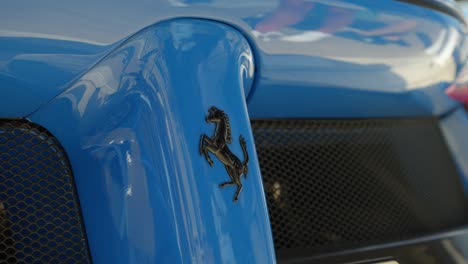close-up of a ferrari emblem on a blue car