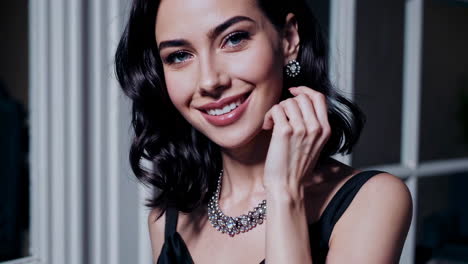 elegant woman smiling and wearing jewelry
