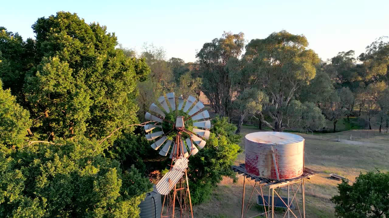 An old tank and windmill on an Australian farm