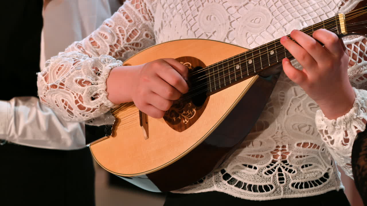 Close-up of a woman playing the mandolin