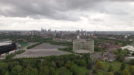 Wide-angle-aerial-view-of-Manchester-city-skyline-on-grey-overcast-day,-UK